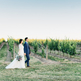 Bride and groom walking vineyards at Sue Ann Staff Estate Winery