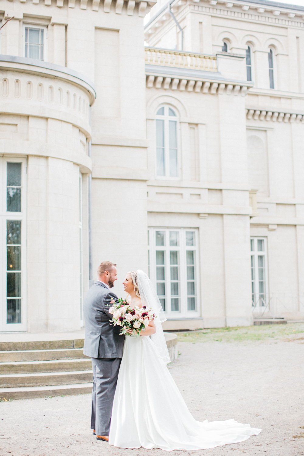 Bride and groom holding each other in front of Dundurn Castle