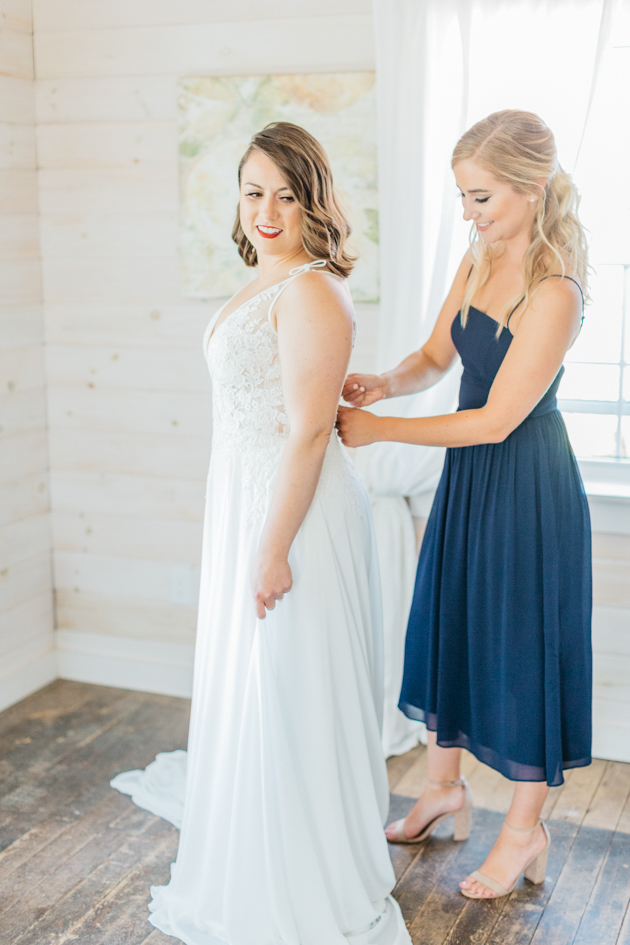 Bridesmaid helping bring get ready at Stonewall Estates