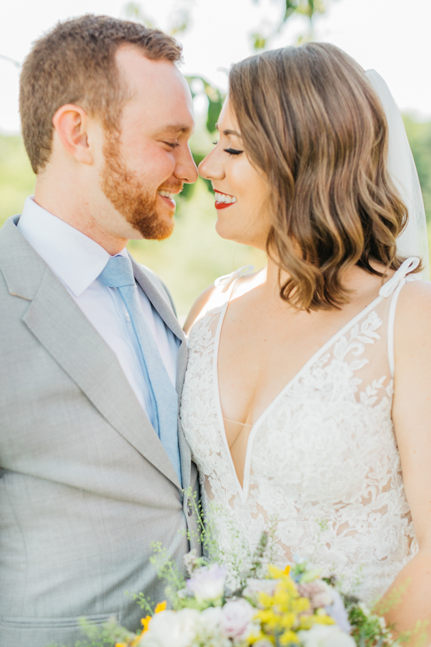 Bride and groom snuggling at Stonewall Estates