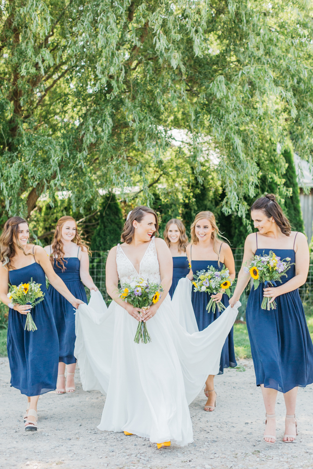 Bridesmaids walking with bride at Stonewall Estates