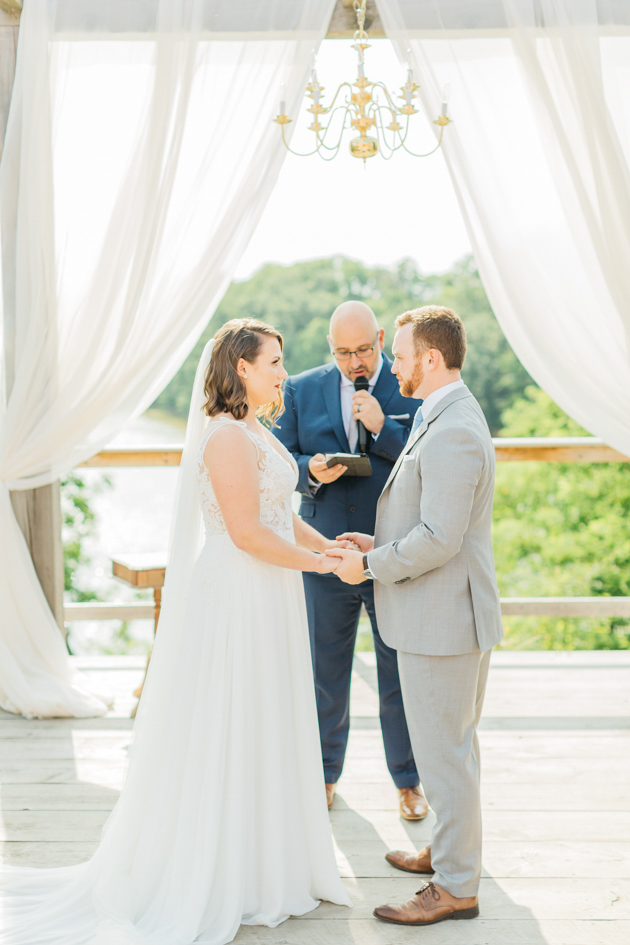 Bride and groom during ceremony at Stonewall Estates