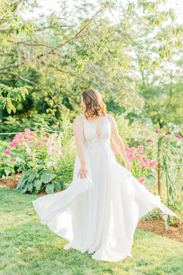 Bride twirling dress during sunset