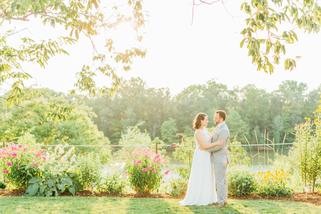 Bride and groom hugging at sunset